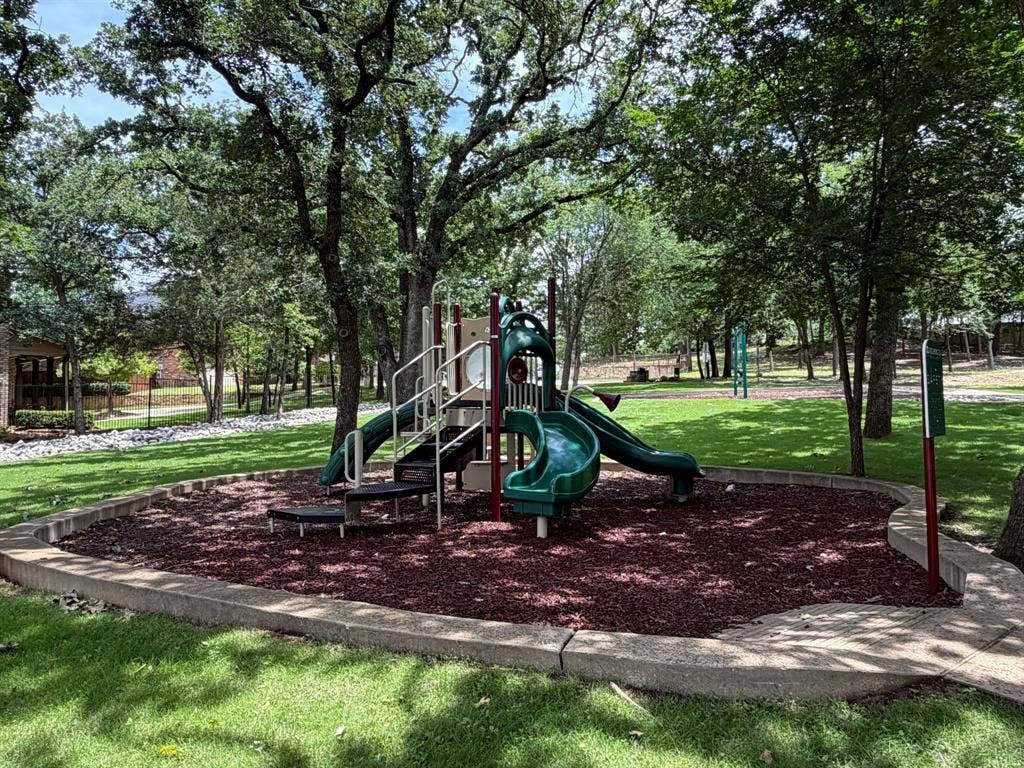 1712 Tealwood Lane, Corinth, TX 76210 Outdoor playground featuring a multi-level structure with slides and climbing elements
