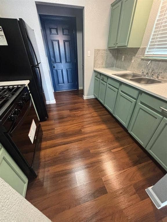 1902 Angelina Drive, Dallas, TX 75212 Kitchen featuring wood-finish flooring, two-tone cabinetry with light green lower and upper cabinets, a dual basin stainless steel sink, and a black appliance suite