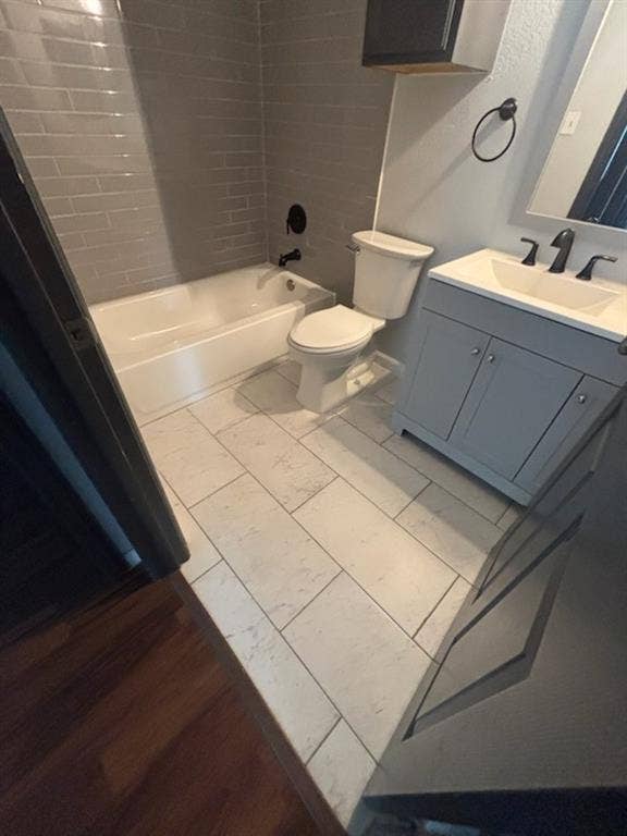 1902 Angelina Drive, Dallas, TX 75212 Bathroom featuring light gray subway tile shower surround and a white bathtub