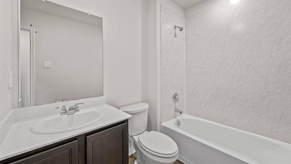 1631 Blaire Drive, Tyler, TX 75702 Bathroom featuring a vanity with dark wood-finish cabinetry, a white countertop, and a white oval undermount sink