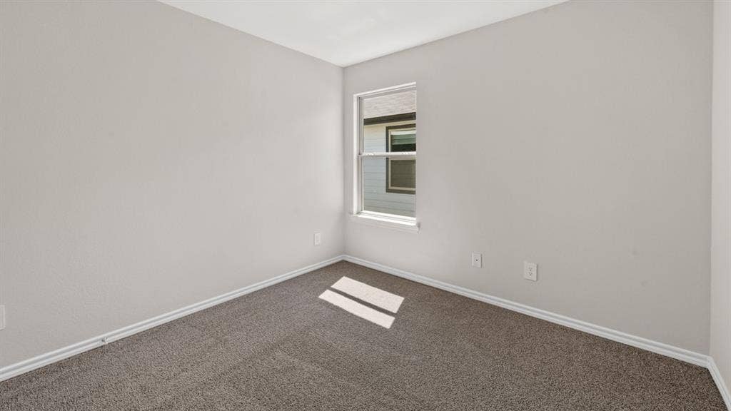 1631 Blaire Drive, Tyler, TX 75702 Neutral-toned interior room featuring light gray walls, white trim, and gray carpet