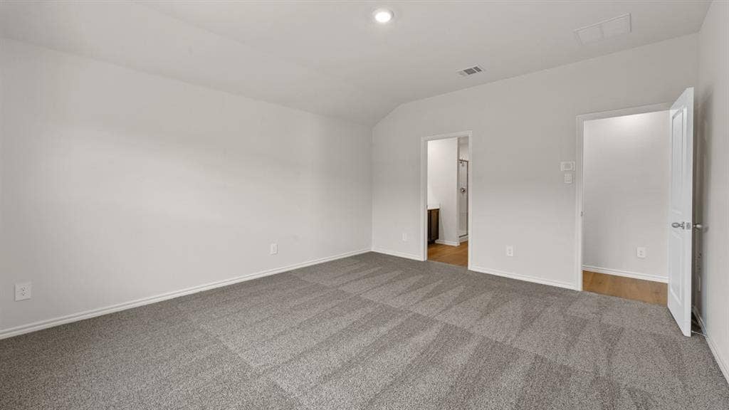 1631 Blaire Drive, Tyler, TX 75702 Spacious room featuring neutral tone walls, patterned gray carpet, and white trim