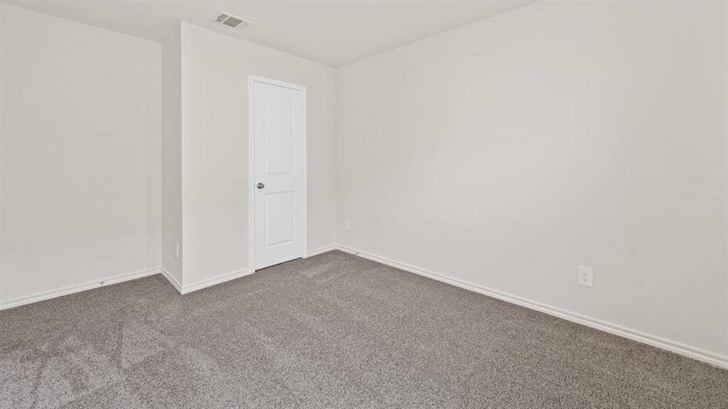 1631 Blaire Drive, Tyler, TX 75702 Neutral wall finishes, textured gray carpeting, and white baseboards
