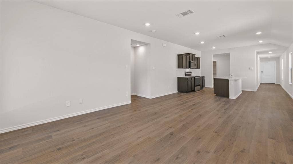1631 Blaire Drive, Tyler, TX 75702 Open-concept living area featuring wood-finish flooring, recessed lighting, and a white interior color palette