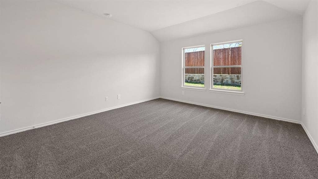 1631 Blaire Drive, Tyler, TX 75702 Spacious room featuring neutral carpeting, white walls, two large windows, white trim, and a vaulted ceiling