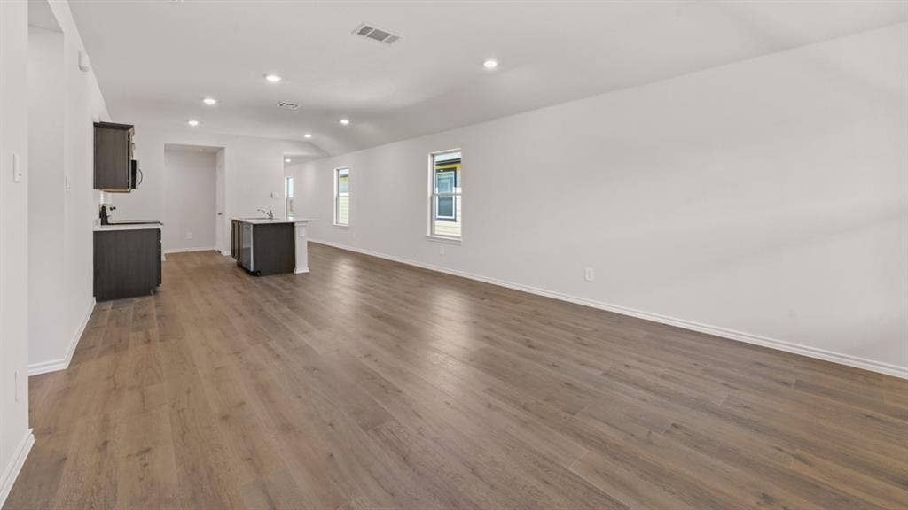 1631 Blaire Drive, Tyler, TX 75702 Open-concept living area featuring wood-finish flooring, recessed lighting, and multiple windows