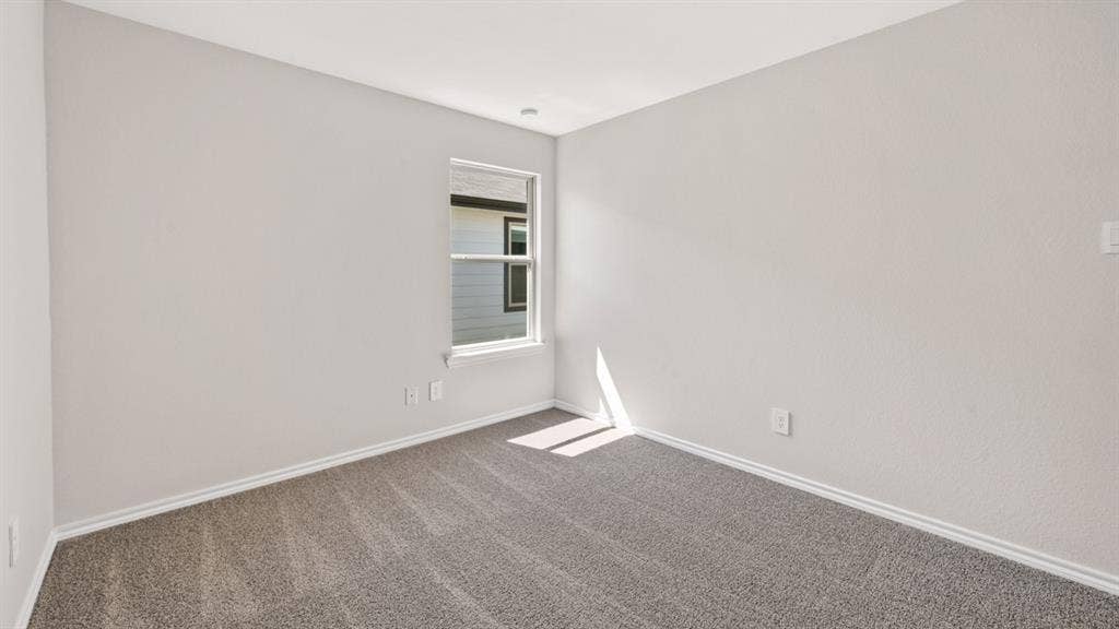 1631 Blaire Drive, Tyler, TX 75702 Neutral-toned walls complement the gray carpeting