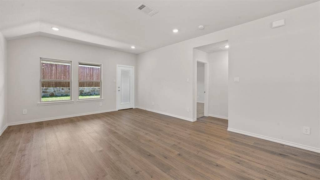 1631 Blaire Drive, Tyler, TX 75702 Spacious room featuring wood-finish flooring, recessed lighting, and a vaulted ceiling