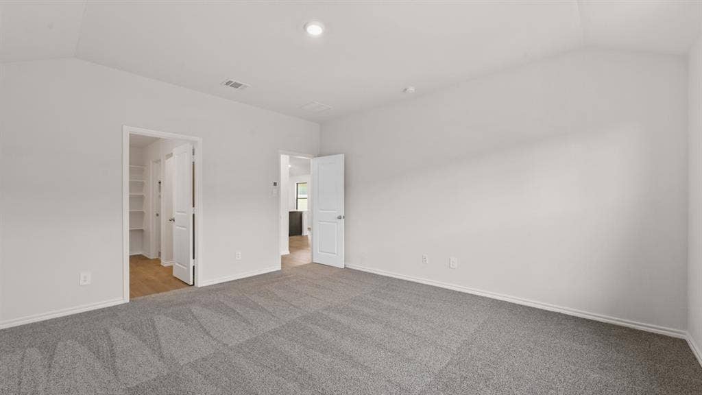 1631 Blaire Drive, Tyler, TX 75702 Spacious room featuring vaulted ceilings and neutral gray carpeting