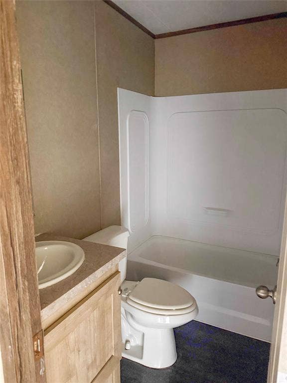 716 Quail Run Court, Seven Points, TX 75143 Bathroom featuring a white bathtub and shower surround, a white toilet, and a vanity with a light-toned countertop and wood-finish cabinetry