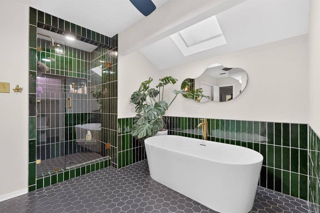 1151 Lynn Way, Waxahachie, TX 75165 Contemporary bathroom featuring a freestanding soaking tub, a frameless glass shower enclosure, and dark green subway tile accents