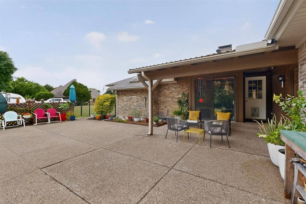 1151 Lynn Way, Waxahachie, TX 75165 Expansive concrete patio area with a covered porch