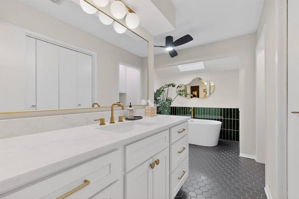 1151 Lynn Way, Waxahachie, TX 75165 Bathroom featuring a white vanity with gold hardware, a white countertop, and gold-finish fixtures