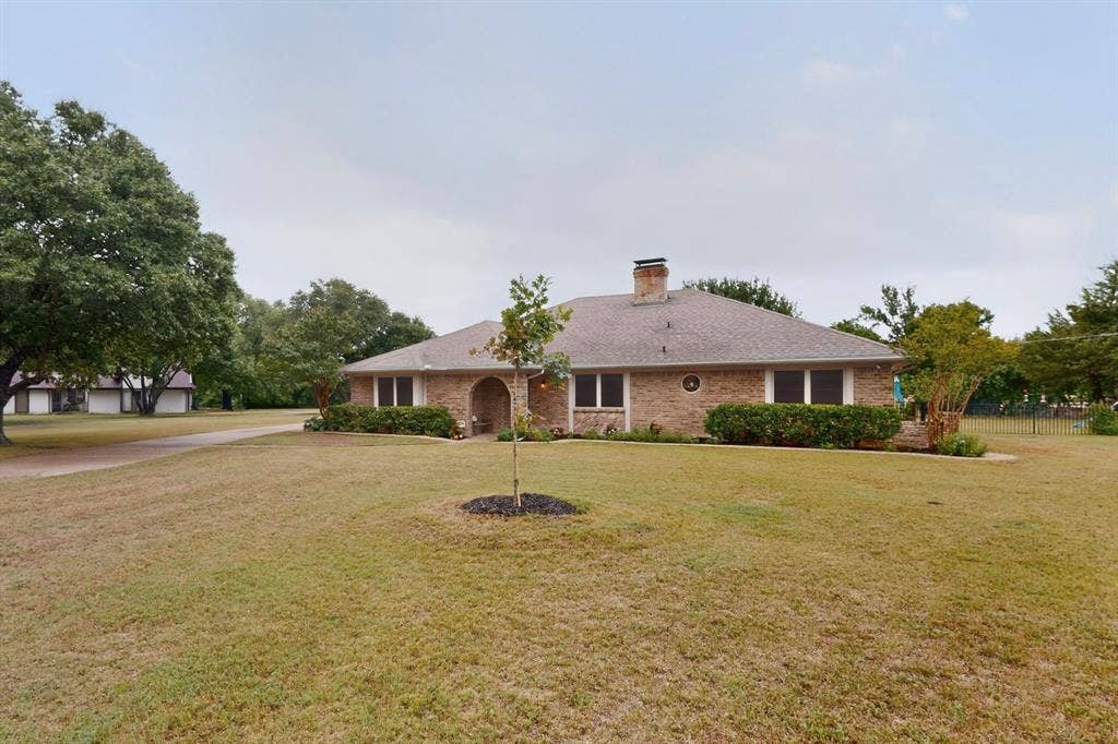 1151 Lynn Way, Waxahachie, TX 75165 Brick exterior residence with an arched entry, and chimney