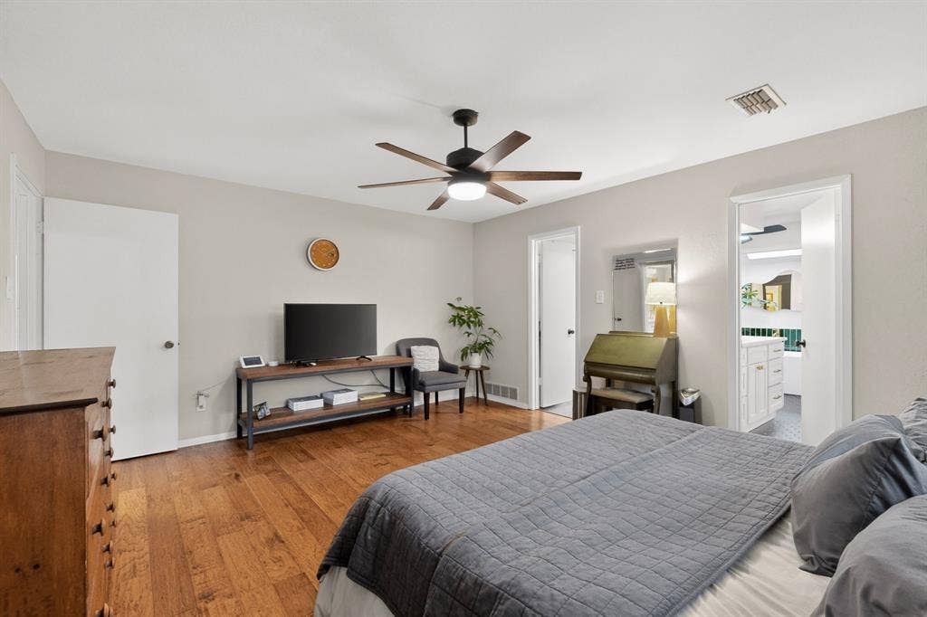 1151 Lynn Way, Waxahachie, TX 75165 Bedroom featuring hardwood flooring and light gray wall paint