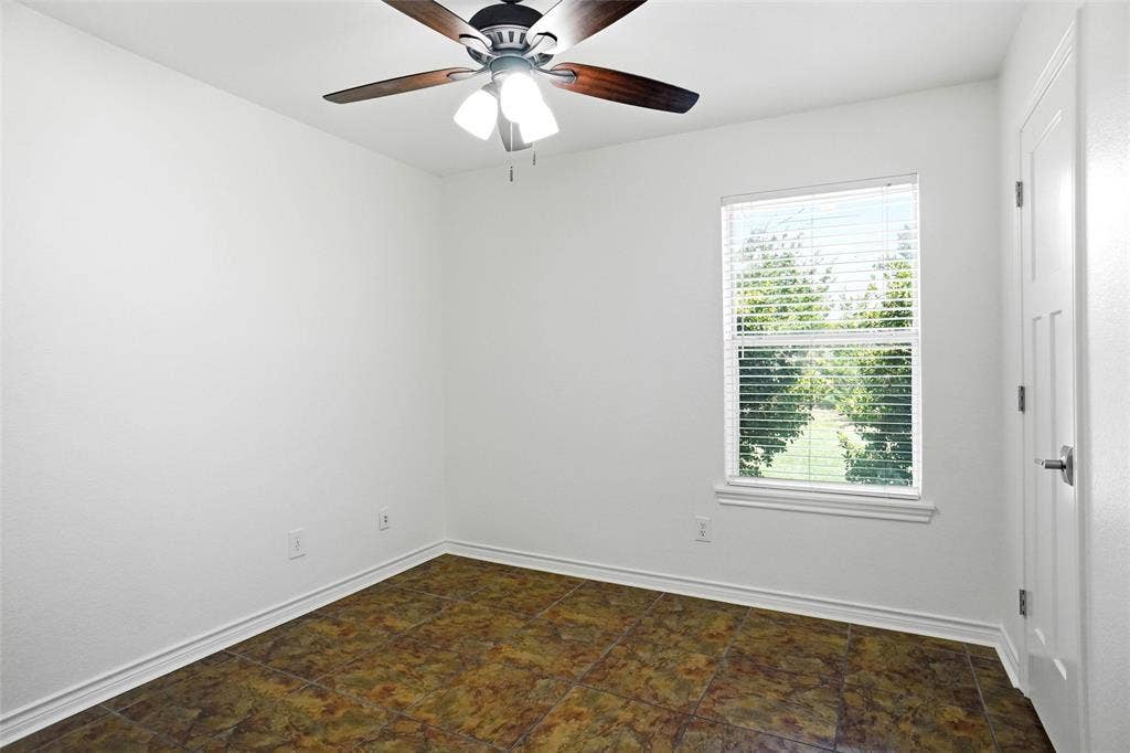 Bedroom featuring windows with horizontal blinds, a ceiling fan with light fixture, tiled flooring, and a closet