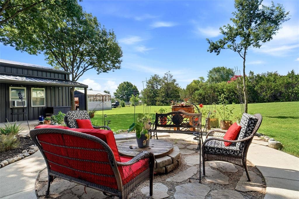 Expansive outdoor patio featuring flagstone paving and a fire pit