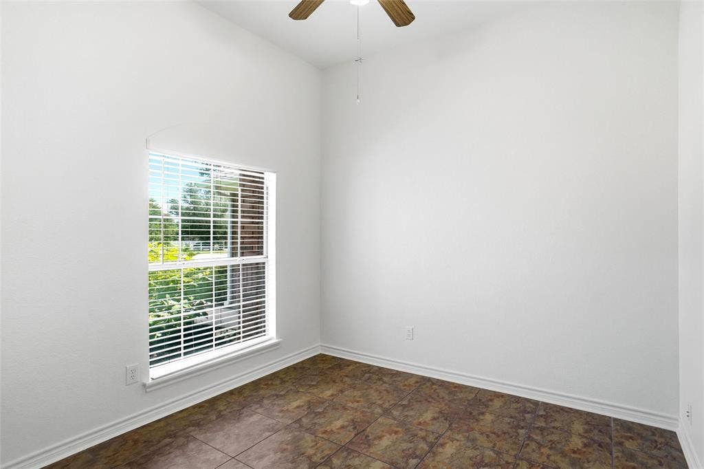 Bedroom featuring window with horizontal blinds, a ceiling fan with light fixture, tiled flooring, and a closet