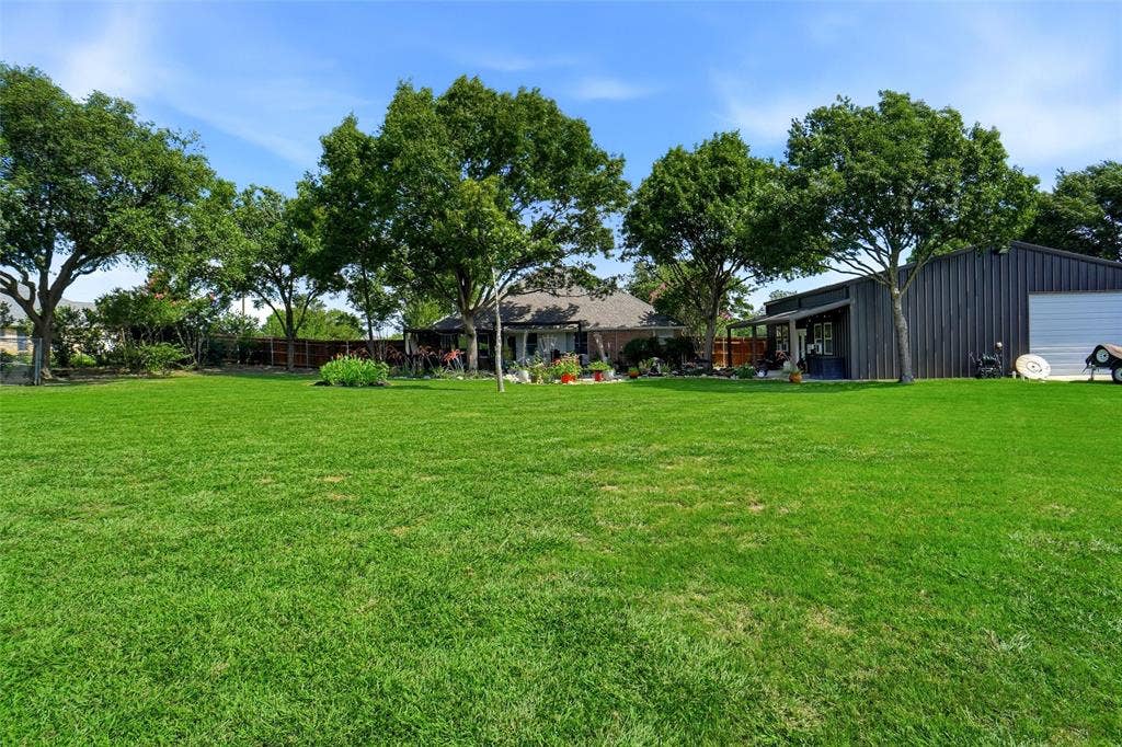 Expansive green lawn with mature trees