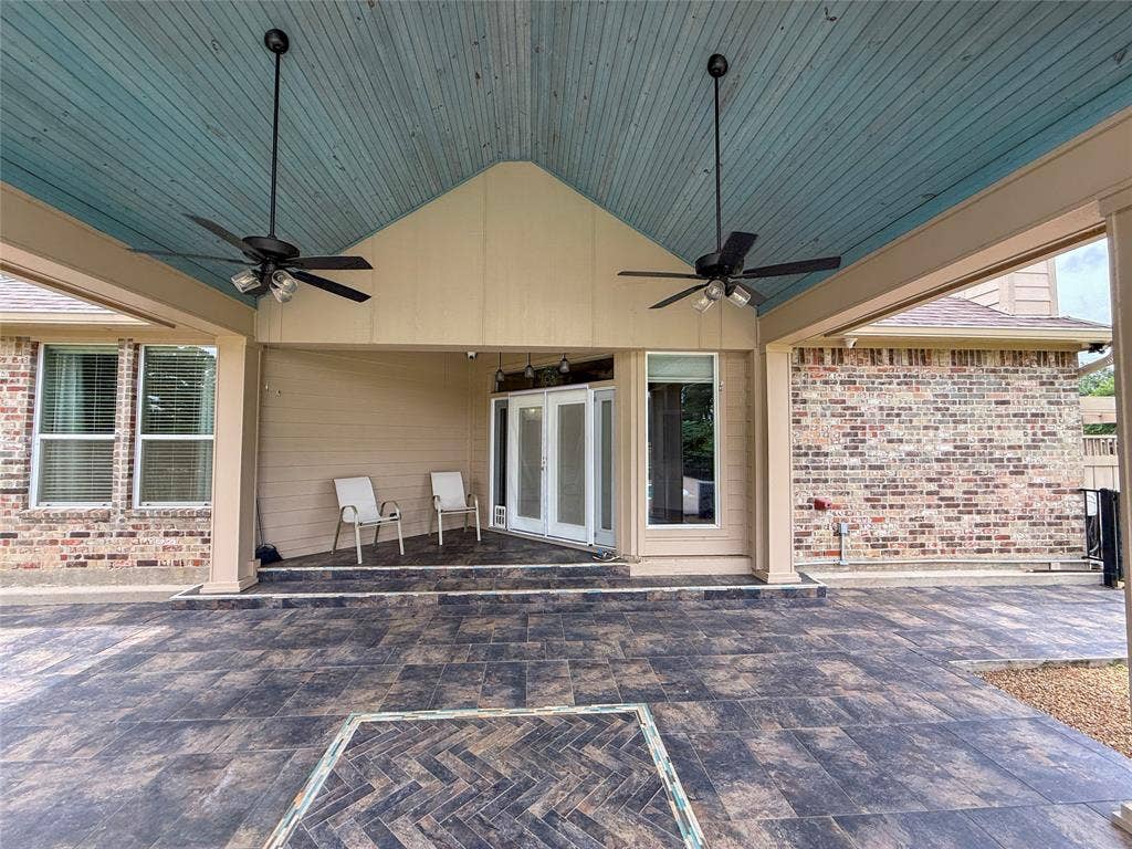 5 Woodlawn Way, Star Harbor, TX 75148 Spacious covered patio with a blue wood-panel ceiling and two ceiling fans