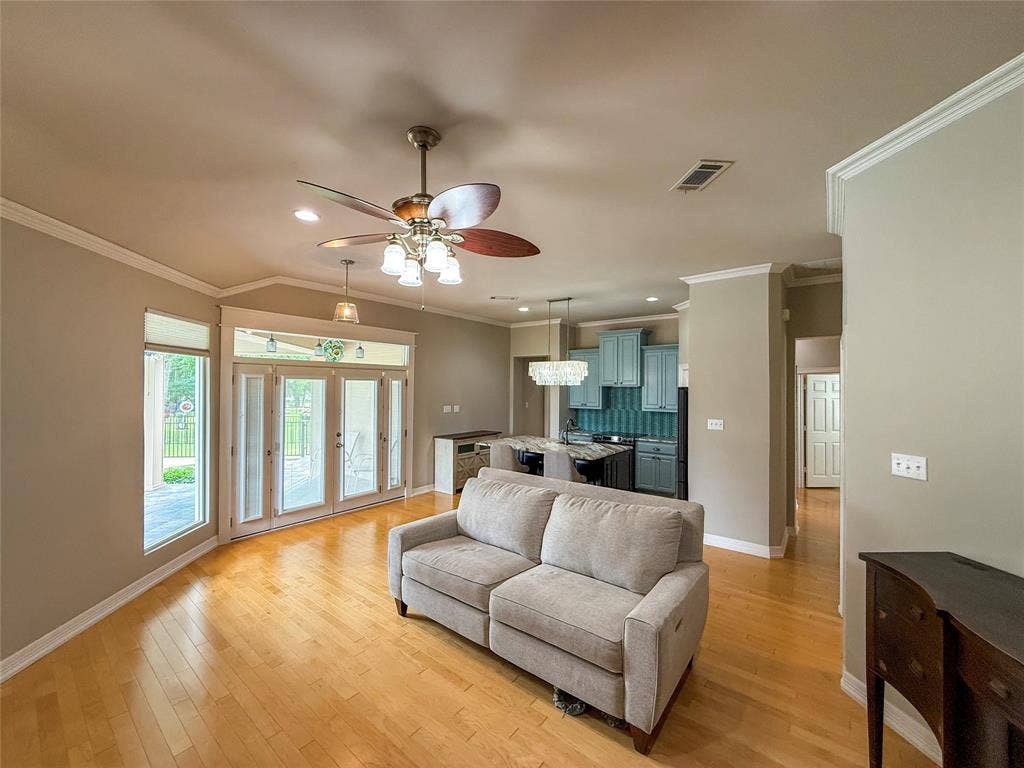 5 Woodlawn Way, Star Harbor, TX 75148 Spacious living area featuring wood-finish flooring, crown molding, and a vaulted ceiling