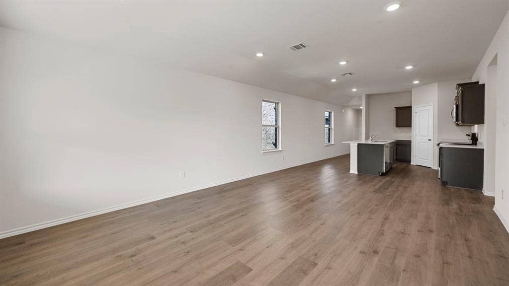 1663 Blaire Drive, Tyler, TX 75702 Open-concept living area featuring wood-finish flooring, recessed lighting, and multiple windows