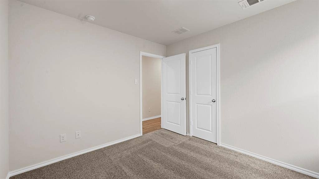 1663 Blaire Drive, Tyler, TX 75702 Carpeted room featuring light neutral wall paint and white trim