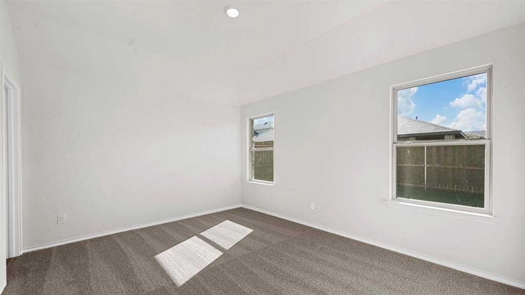1663 Blaire Drive, Tyler, TX 75702 Spacious room featuring neutral paint, gray carpeting, two windows, and a recessed ceiling light