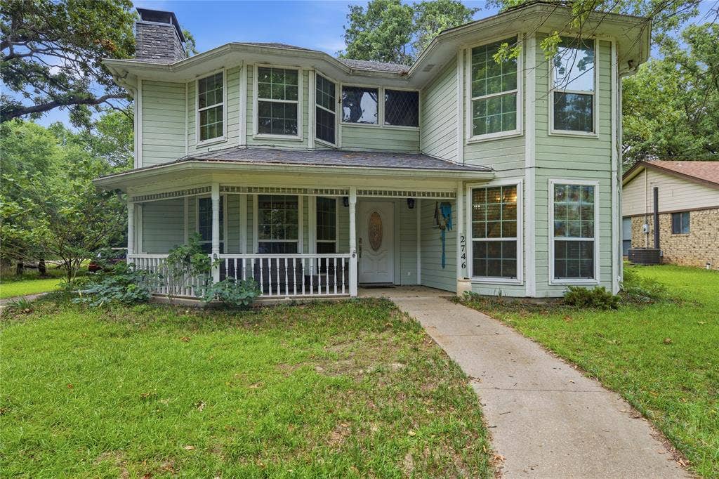 2746 Hopson Drive, Athens, TX 75752 Two-story residence featuring light green siding and a covered front porch with white railings