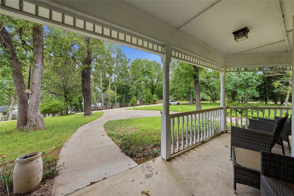 2746 Hopson Drive, Athens, TX 75752 Covered front porch featuring white balusters and a decorative ceiling trim