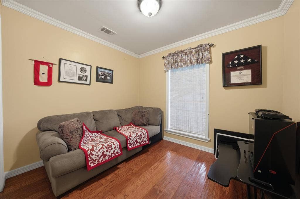 2746 Hopson Drive, Athens, TX 75752 Versatile interior space featuring wood-finish flooring, light-colored walls, and classic crown molding