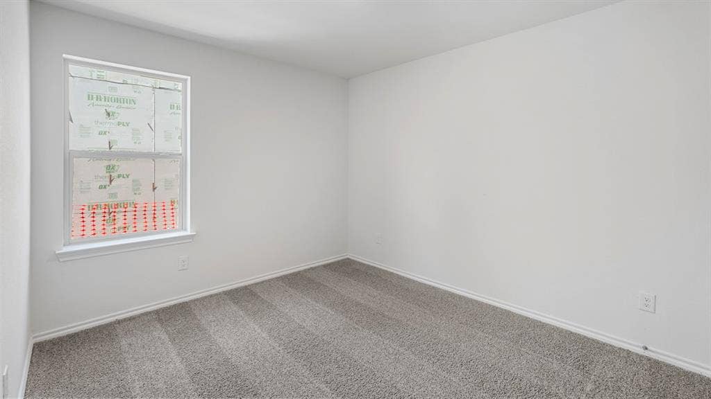 1659 Blaire Drive, Tyler, TX 75702 Room featuring a double-hung window, light gray carpet, white baseboards, and a neutral wall color