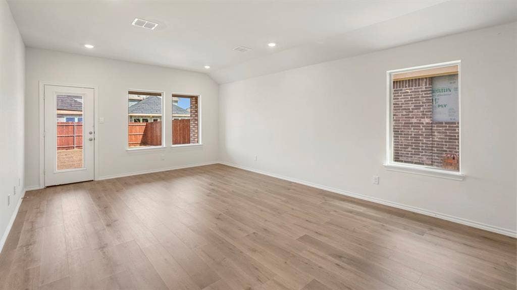 1659 Blaire Drive, Tyler, TX 75702 Spacious room featuring light wood-finish flooring, recessed lighting, and a vaulted ceiling