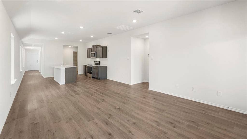 1659 Blaire Drive, Tyler, TX 75702 Open-concept living space featuring wood-finish flooring and recessed lighting