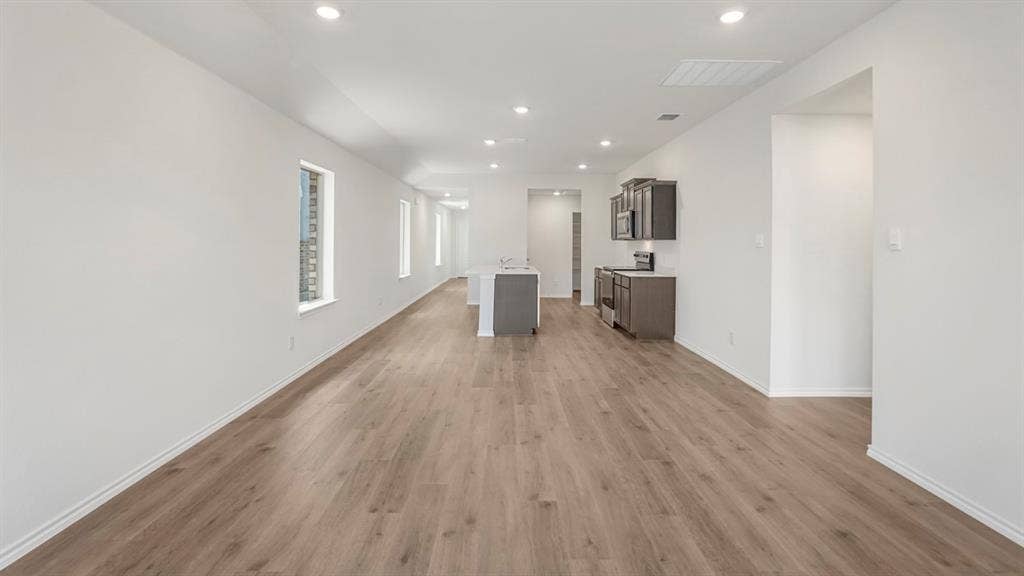 1659 Blaire Drive, Tyler, TX 75702 Open-concept living area with wood-finish flooring, recessed lighting, and white baseboards