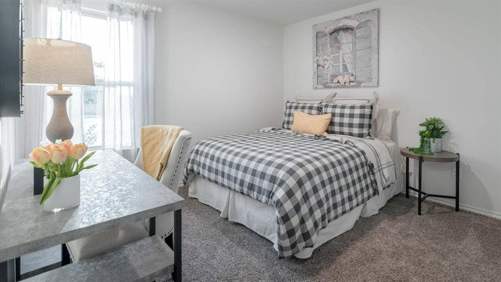 1627 Blaire Drive, Tyler, TX 75702 Bright interior room featuring a window with sheer white coverings, neutral wall paint, and gray textured carpeting