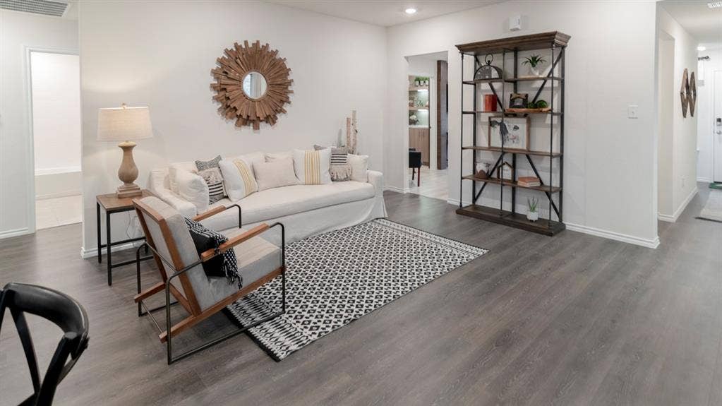 1627 Blaire Drive, Tyler, TX 75702 Spacious living area featuring plank wood-finish flooring, white walls, and a recessed lighting fixture