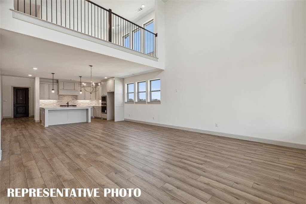 1290 Chickadee Street, Prosper, TX 75078 With the family room open to the game room above, you'll enjoy multi-level entertaining in this dream home! REPRESENTATIVE PHOTO