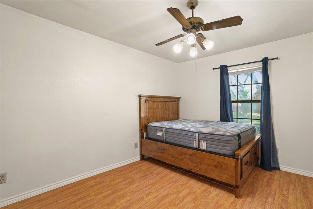 1037 Whitewater Trail, DeSoto, TX 75115 Interior room featuring wood-finish flooring, a ceiling fan with integrated lighting, and a window with natural light