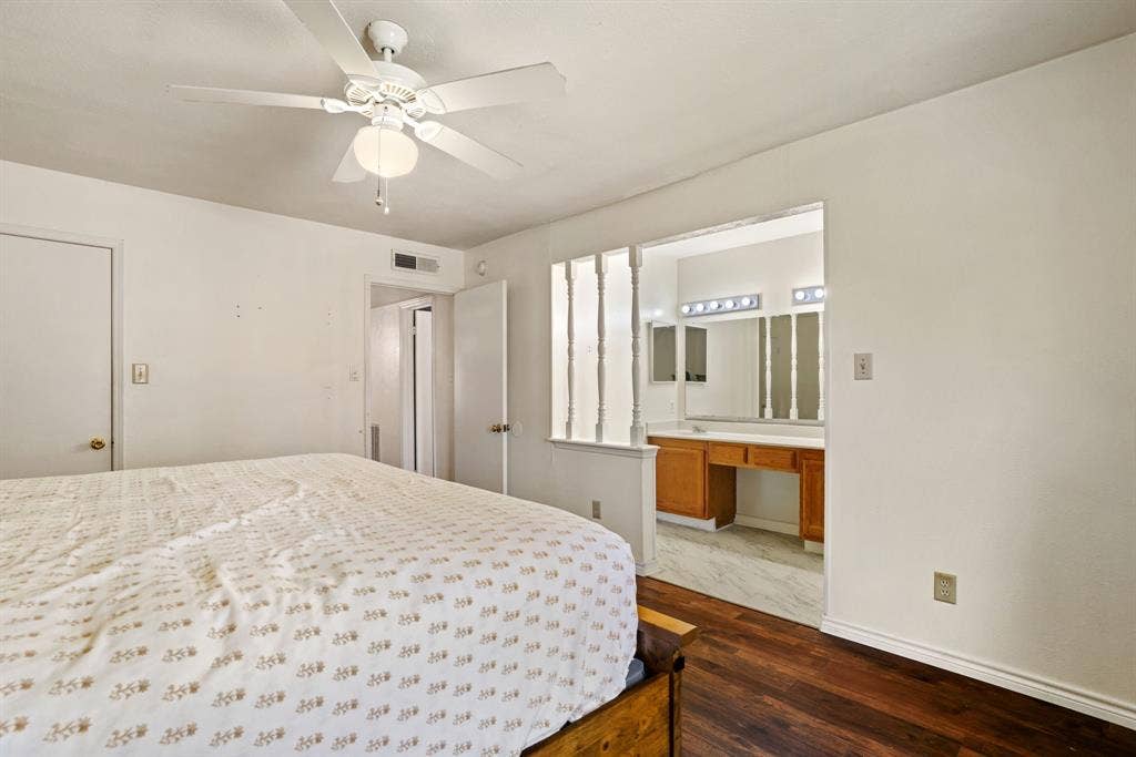 1037 Whitewater Trail, DeSoto, TX 75115 Bedroom featuring wood-finish flooring, a ceiling fan with integrated lighting, and direct access to a vanity area with a built-in wooden vanity
