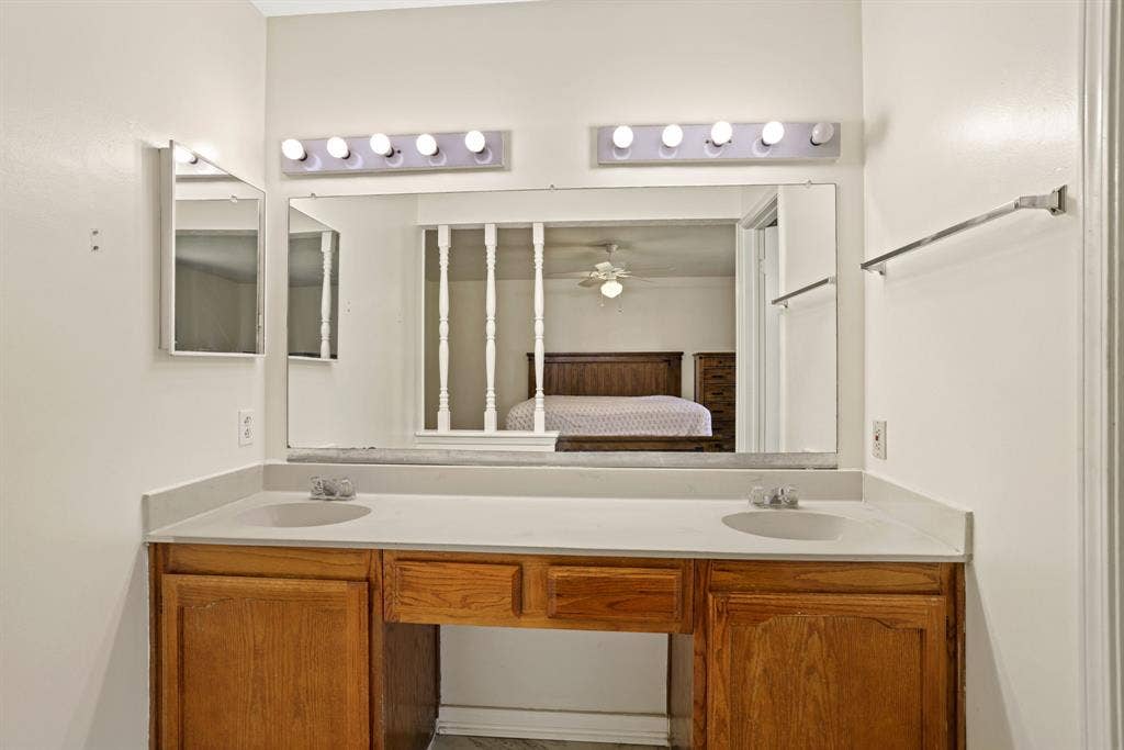 1037 Whitewater Trail, DeSoto, TX 75115 Double vanity with a light-toned countertop and wood-finish cabinetry