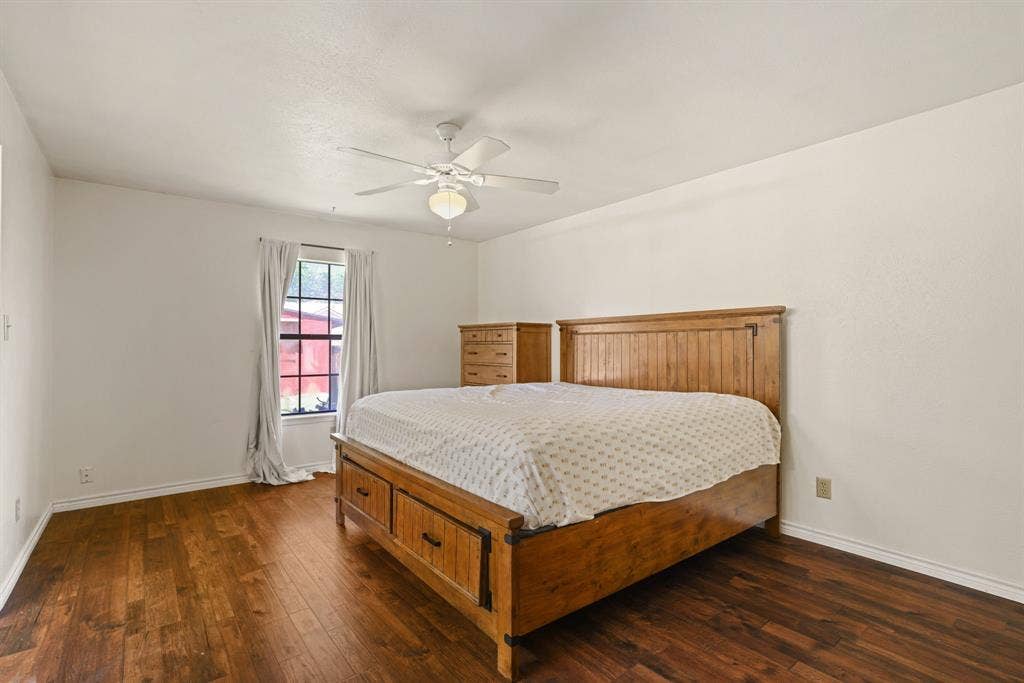1037 Whitewater Trail, DeSoto, TX 75115 Spacious room featuring wood-finish flooring, a window with natural light, a ceiling fan with integrated lighting, and white baseboards