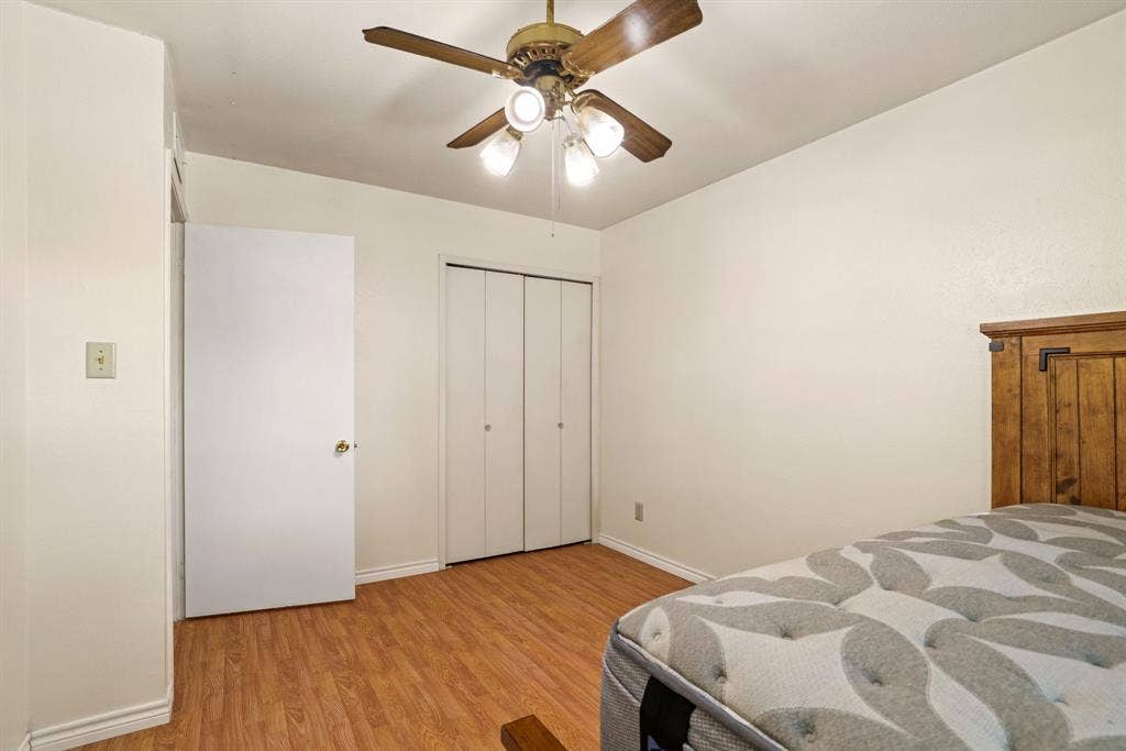 1037 Whitewater Trail, DeSoto, TX 75115 Room featuring wood-finish flooring, a ceiling fan with integrated lighting, and a closet with bifold doors