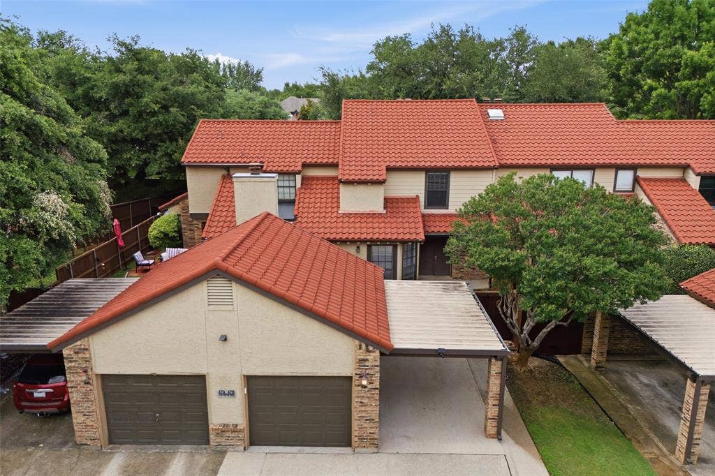 4130 Proton Drive, #47B, Addison, TX 75001 Daytime aerial view highlighting the one-car detached garage, and covered parking for an additional vehicle.
