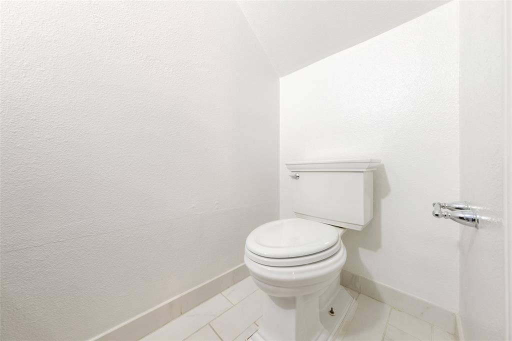 4130 Proton Drive, #47B, Addison, TX 75001 Updated half-bath with a white vessel sink, sleek chrome faucet, quartz countertop, and dark wood cabinetry — a modern, clean finish for guests.