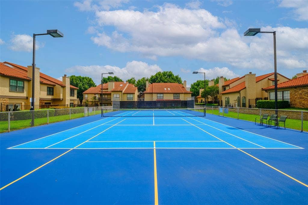 4130 Proton Drive, #47B, Addison, TX 75001 Tennis and pickleball court with LED sports lighting, and a fenced enclosure — a standout amenity right within the community.
