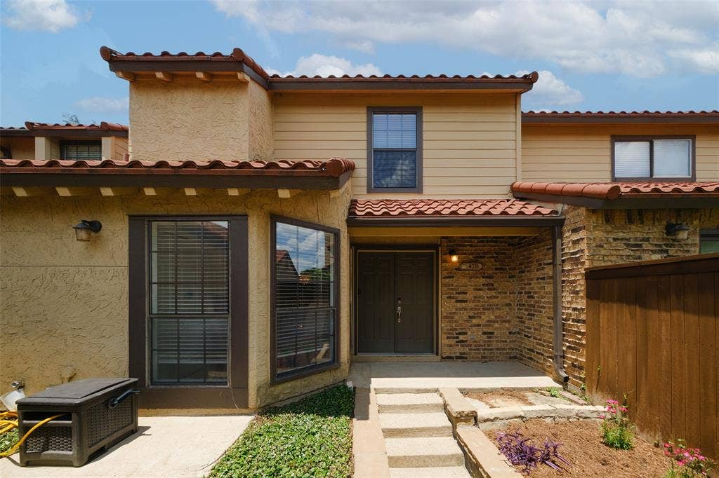 4130 Proton Drive, #47B, Addison, TX 75001 Front entry featuring brick accent columns, clay tile roof line, covered entry porch, and lush landscaping — classic La Mirada character.