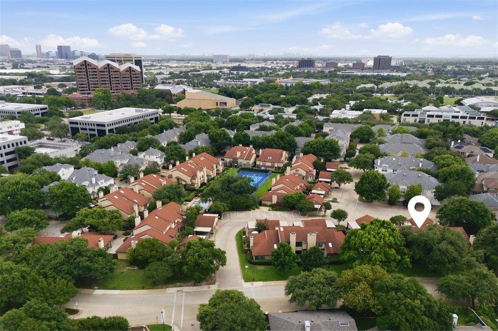 4130 Proton Drive, #47B, Addison, TX 75001 Wide aerial perspective of La Mirada's full footprint surrounded by mature tree canopy, with the Addison skyline in the background — highlighting the rare combination of a quiet, green neighborhood setting with immediate urban access.