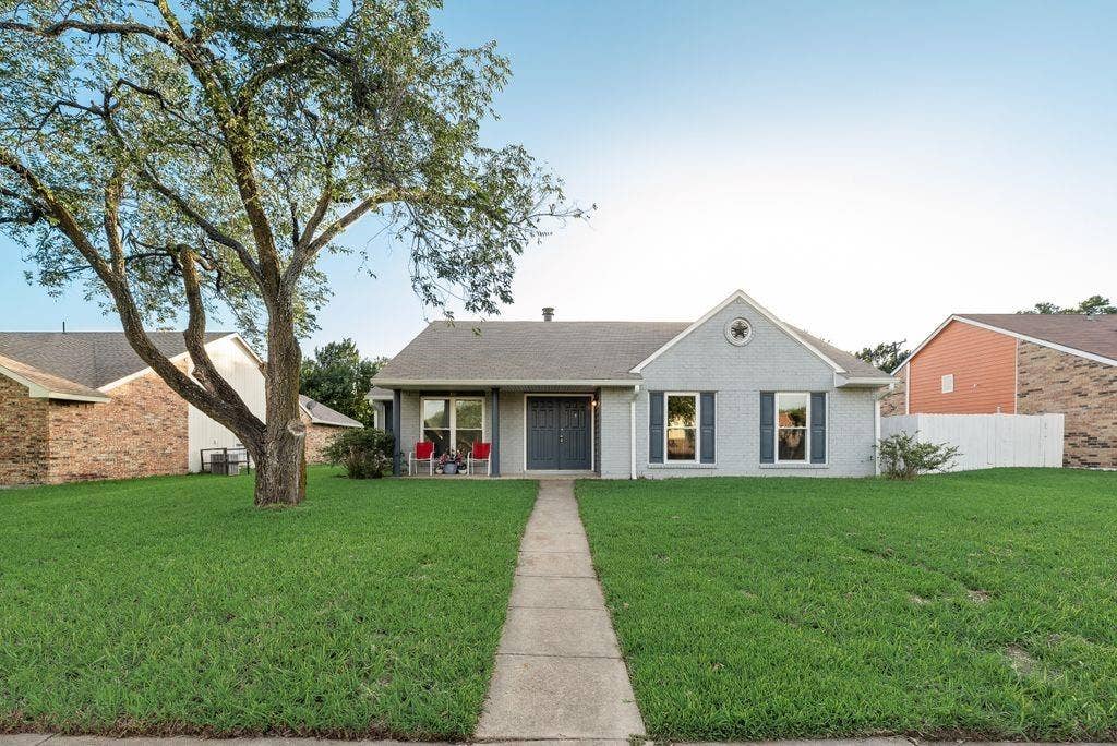316 Matterhorn Street, Cedar Hill, TX 75104 Single-story residence featuring a light gray brick exterior with dark shutters