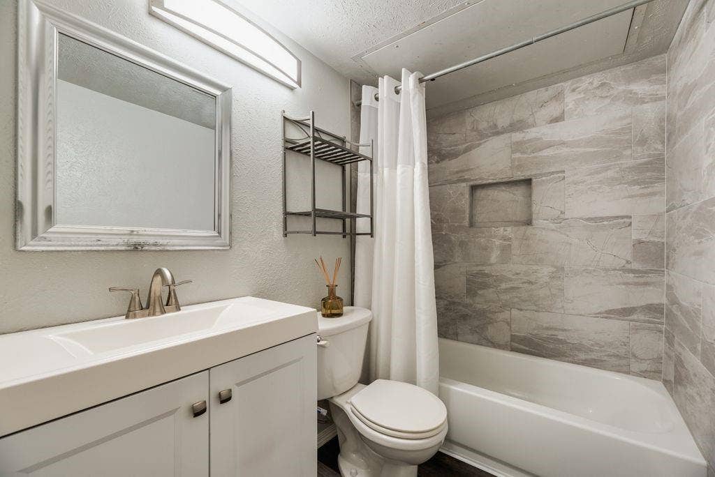 316 Matterhorn Street, Cedar Hill, TX 75104 Bathroom featuring a white vanity with integrated sink, brushed nickel faucet, and a framed mirror